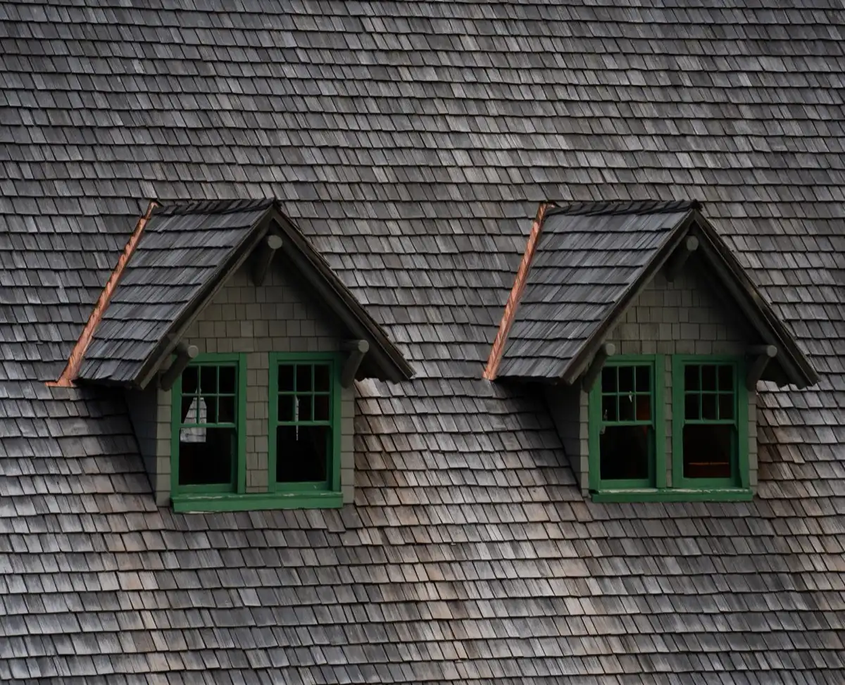 Dormers on a shingle roof in Raleigh, NC, where step flashing and kickout flashing carry water past the walls