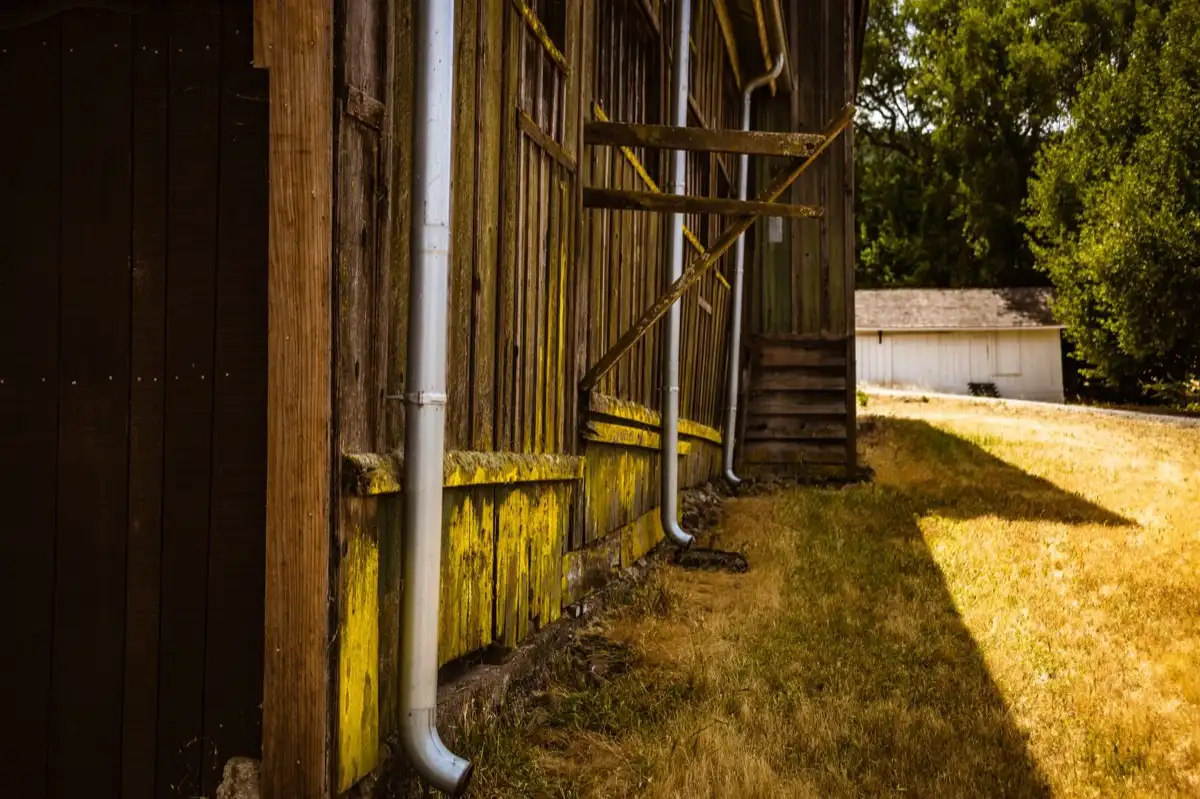 Roof edge, fascia and downspout on a house in Raleigh, NC, where drip edge carries runoff into the gutter